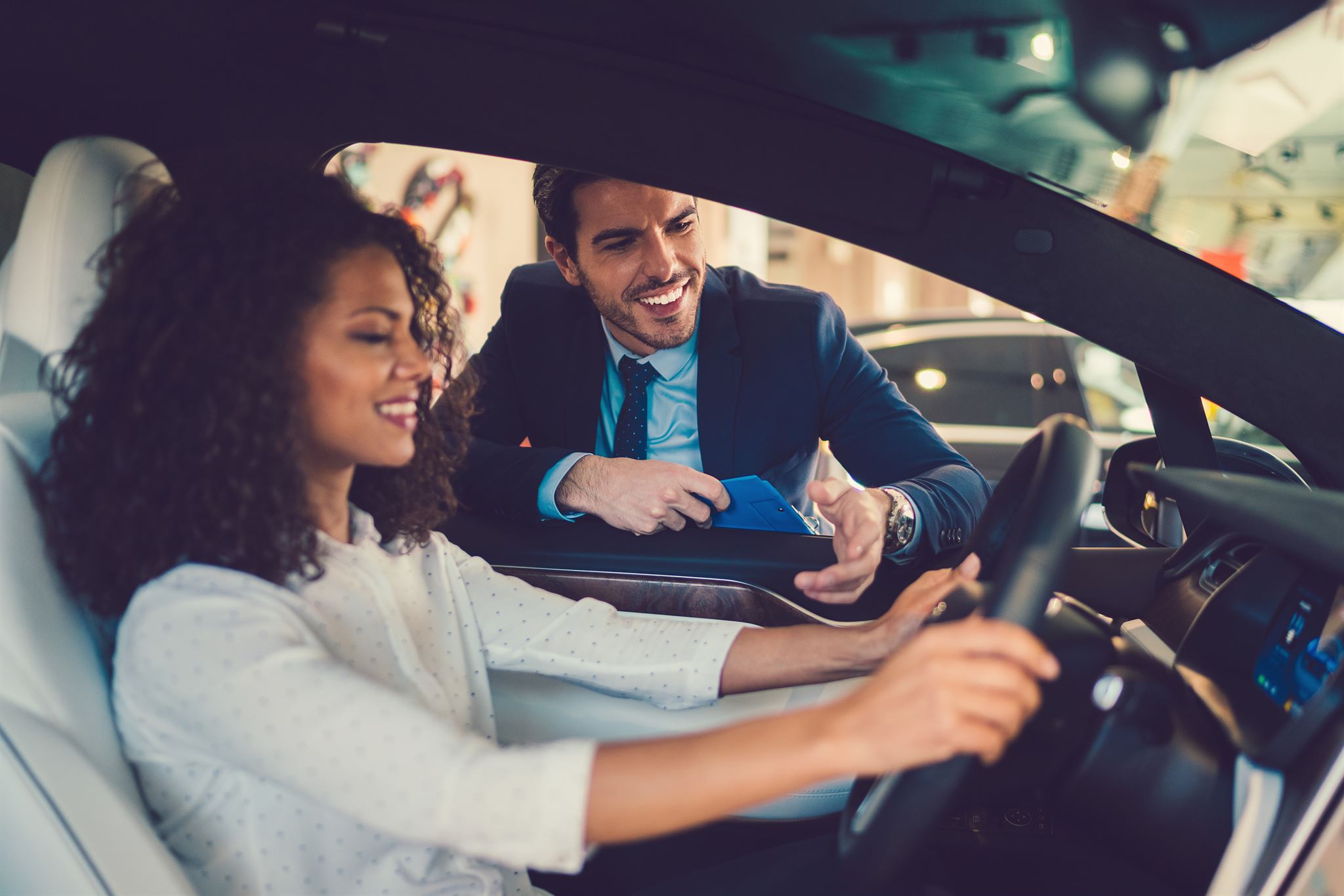 Woman-sitting-in-driving-seat-testing-car